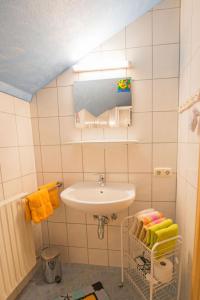 a white bathroom with a sink and a towel rack at Bergbauernhof Untermoos in Taxenbach +41 photos