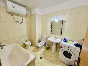 a bathroom with a toilet sink and a washing machine at Casa del Mar 2-Sea view Vollga, 2BR in Durrës +29 photos