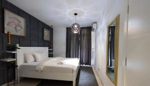 Postel nebo postele na pokoji v ubytování Oasis Apartments Gh by Embassy Gardens + 26 fotografií