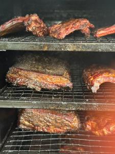 a rack of ribs and bacon cooking in an oven at Danys House at Tiki Bar and More in Nusa Lembongan