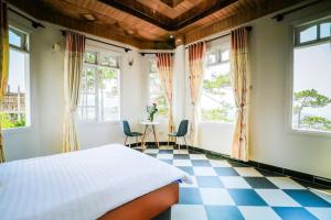 a bedroom with a bed and a checkered floor at Moon Villa Da Lat in Ấp Ða Lợi +38 photos