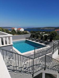 a view of a swimming pool on a balcony at Villa Seget Large Villa all for you in Seget Vranjica