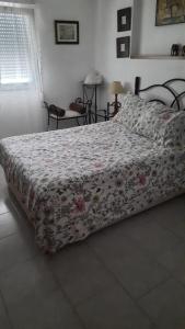a bedroom with a bed with a floral bedspread at valenia city in Valencia