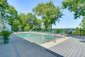una piscina en una terraza con sillas alrededor en Osage Beach Home with Private Hot Tub Near Lake!, en Osage Beach