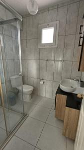 a bathroom with a toilet and a sink at Monix Homes-Villa Magic Garden in Kaş +25 photos