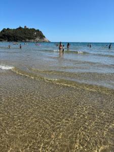 a group of people in the water at the beach at Acquamarina in Gaeta