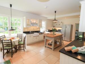 a kitchen with a table and a dining room at Little Ellers in Portinscale