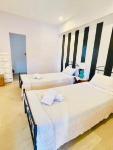 a room with three beds in a room at Villa Maria 1 in Paleokastritsa