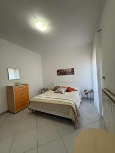 a bedroom with a bed and a dresser in it at Mariù in Agira