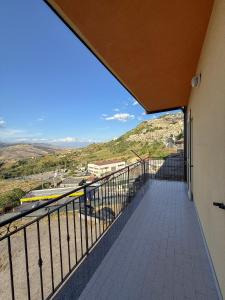 a balcony with a view of a city at Mariù in Agira