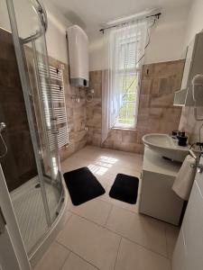 a bathroom with a shower and a sink at Partium Hotel Szeged in Szeged +28 photos