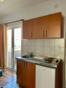 a kitchen with a sink and a stove top oven at Cache Apartments in Ulcinj