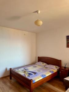 a bedroom with a bed in a room with a ceiling at Cache Apartments in Ulcinj
