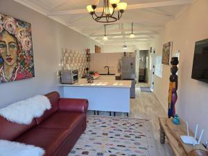a living room with a couch and a kitchen at The Garage in Sedgefield