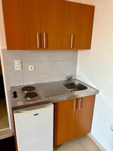 a small kitchen with a sink and a stove at Cache Apartments in Ulcinj +20 photos