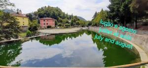 a bridge over a river with a reflection in the water at La Casetta - Locazione turistica in Voltaggio
