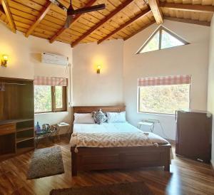 a bedroom with a bed and a large window at Woody Trails - Astronomy, Graphology, Family, Kainchi Dham in Bhowāli +62 photos