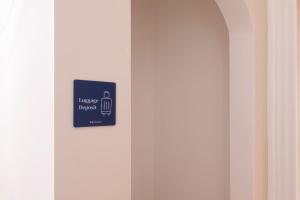 a sign on the side of a white door at RELSTAY - Assarotti Suites in Genoa +35 photos