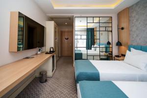 a hotel room with a bed and a desk at ANGEL'S PARK HOTEL in Denizli