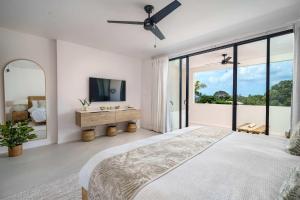 a bedroom with a bed and a large window at Walk to Beach, NEW LUX 4BD Villa & Pool! Near Holetown in Saint James +10 photos