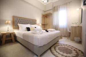 a bedroom with a large bed with towels on it at ILIOS apartment in Nydri