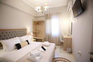 a bedroom with a large bed with towels on it at ILIOS apartment in Nydri