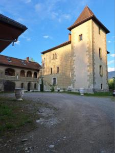 a large brick building with a clock tower at L'Appart' du Château - Annecy 15 min in Alby