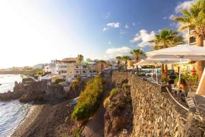 Blick auf einen Strand mit Gebäuden und das Meer in der Unterkunft KALI - Apartment Tenerife Sur in Alcalá