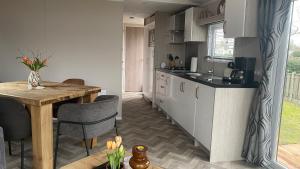 a kitchen with a table and a dining room at Chaletspecials Makkum in Makkum +5 photos