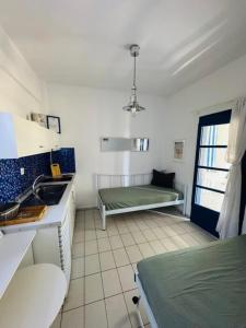a kitchen with a sink and a bed in a room at Mikri elia beach in Lagomandra