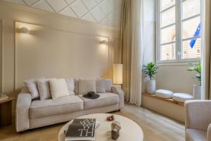 a living room with a couch and a table at Deservi Charming Apartments in Florence