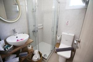 a bathroom with a shower and a toilet and a sink at ILIOS apartment in Nydri +20 photos