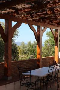 a table and chairs on a porch with a view at Cortijo Al-Andalus in Órgiva