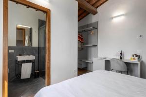 a bedroom with a bed and a sink and a mirror at B&B Panizzi - San Gimignano in San Gimignano +79 photos