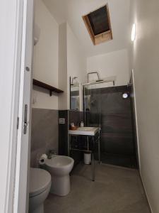a bathroom with a sink and a toilet and a mirror at La Casina in Amelia