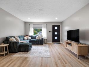 a living room with a couch and a flat screen tv at 291 Hunter Ave bungalow 