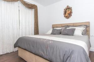 a bedroom with a large bed with gray and white pillows at Villa Seget Large Villa all for you in Seget Vranjica +27 photos