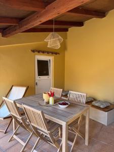 a dining room with a wooden table and chairs at Zio Nino in Sutomišćica