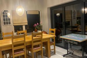 a dining room with a wooden table and chairs at Cozy Dover House with 4 Bedrooms in Dover