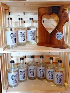 a shelf with several bottles of whiskey on it at Sinnvoll - Ferienwohnung1 in Sankt Anna am Aigen