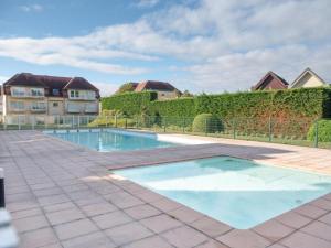 a swimming pool in the middle of a yard at Sun and Sea De Haan in De Haan