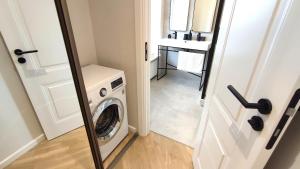 a laundry room with a washing machine and a sink at Stylish Riga Old Town getaway in Riga