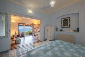 a bedroom with a bed and a view of the ocean at Villa Ikigai, luxury, sea view swimming pool in Porto Rafael