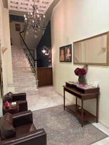 a living room with a table and a staircase at Le Bijou Luxury Rooms & Suites in Veria