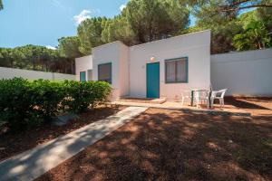 a white house with a table and chairs in a yard at Miravacanze Peschici in Peschici +8 photos