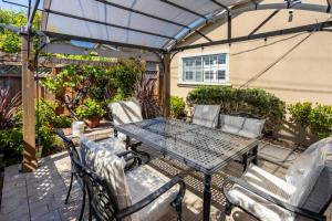 a patio with a table and chairs and an umbrella at Wine Waves & Comfort 2BR Bay Area Beauty in Hayward