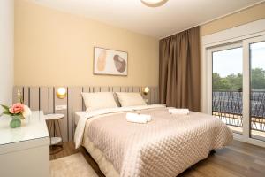 Ein Bett oder Betten in einem Zimmer der Unterkunft VSG Resort - Apartments 200m from Beach, Pool, Sauna & Jacuzzi