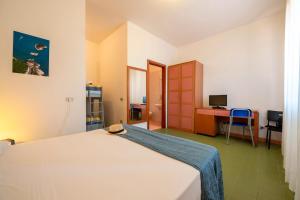 a bedroom with a bed and a desk with a computer at Miravacanze Peschici in Peschici