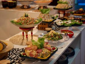 a buffet with many plates of food on a table at Dar Ba Sidi & Spa Chefchaouen in Chefchaouen