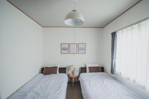 Postel nebo postele na pokoji v ubytování AKIYATO DATE DREAM DATE home